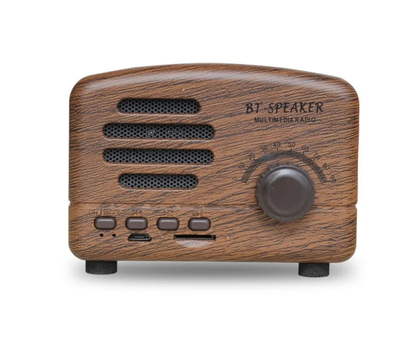 Vintage wood effect Bluetooth speaker in pink, black and wood grain colours showing compact size