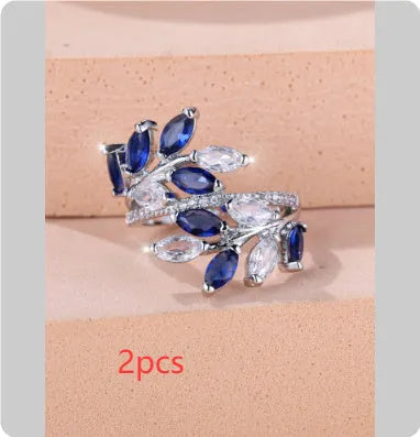 Adjustable copper leaf ring in platinum or rose gold finish on a white background