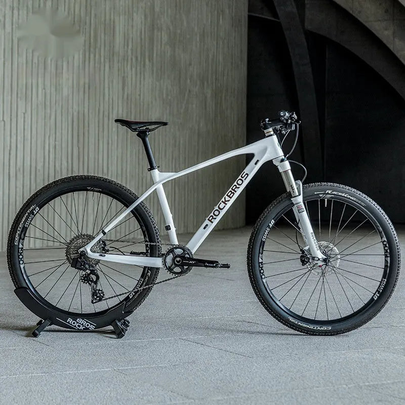 Black ABS plastic wall-mounted bicycle parking rack holder holding a mountain bike.