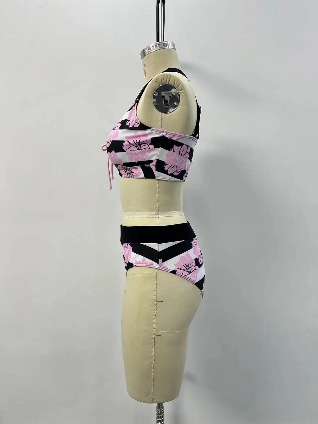 Black women's bikini with covered belly and split style for swimming.