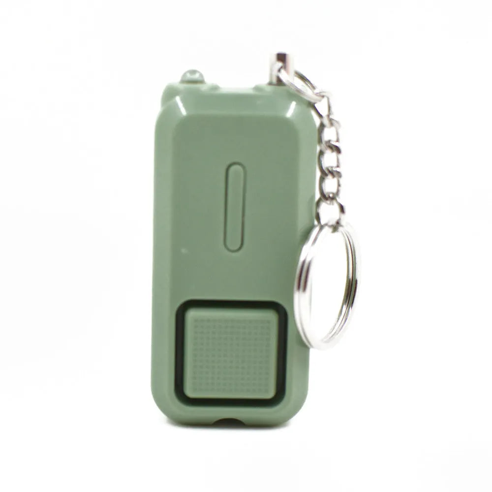 Small pink personal safety alarm with keyring, shown next to its white packaging box.