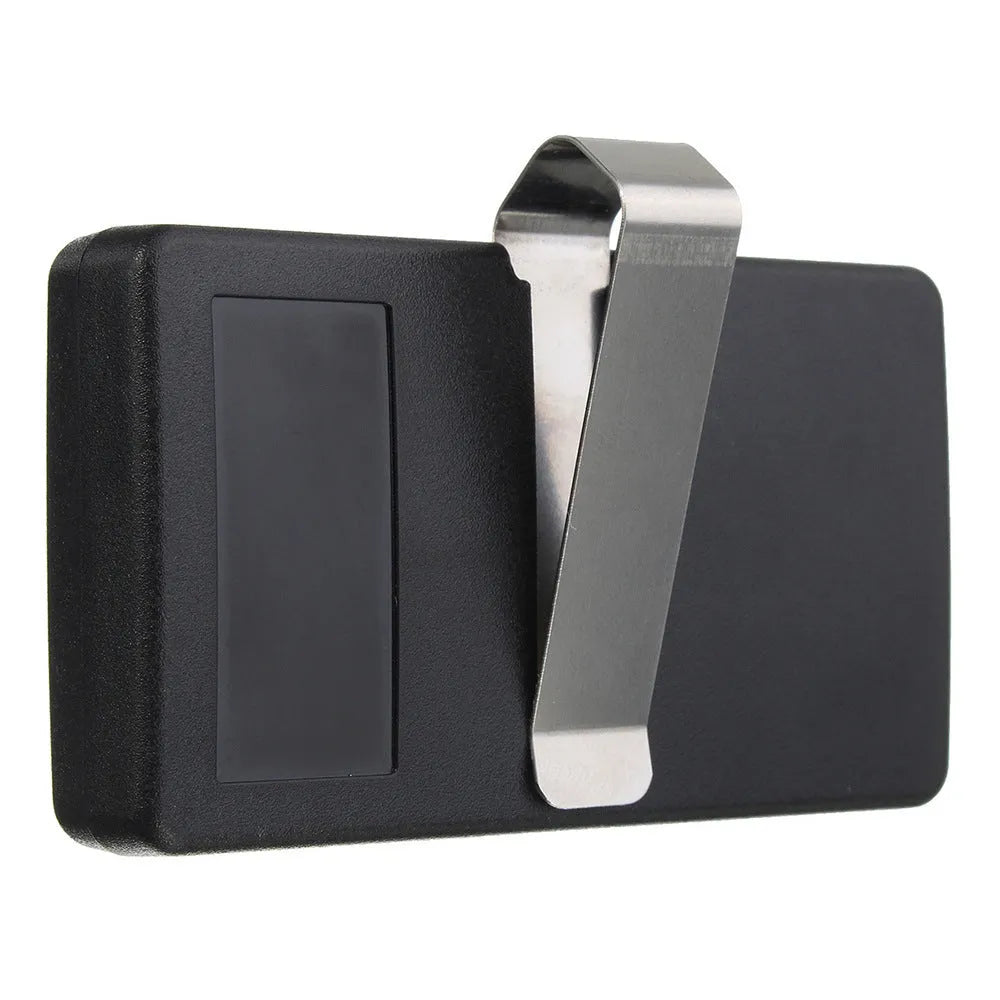 Black plastic three-button garage door remote control next to a CR2032 battery.