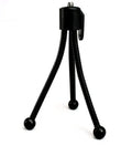 Small silver mini tripod with ball head shown extended on a desktop next to a mobile phone.