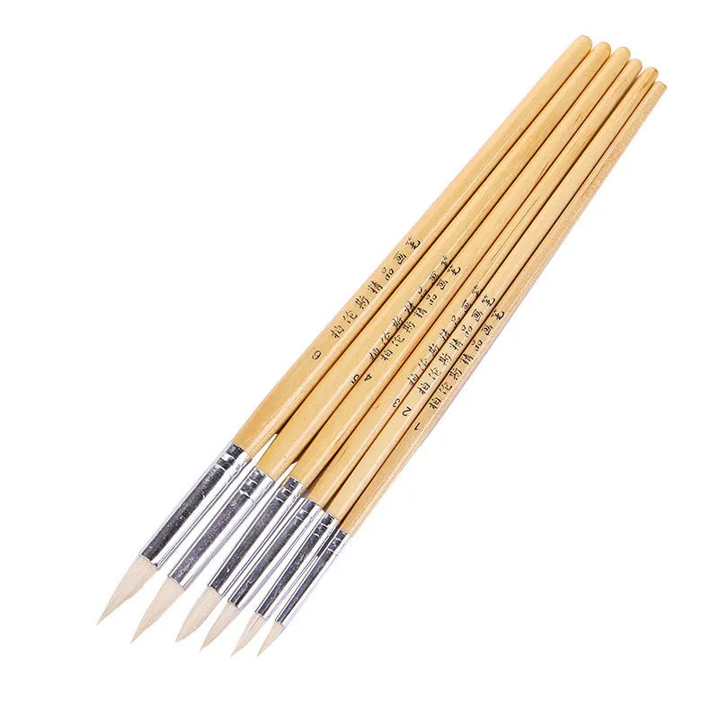 Set of six wooden hook line pen brushes for yarn craft on a table.