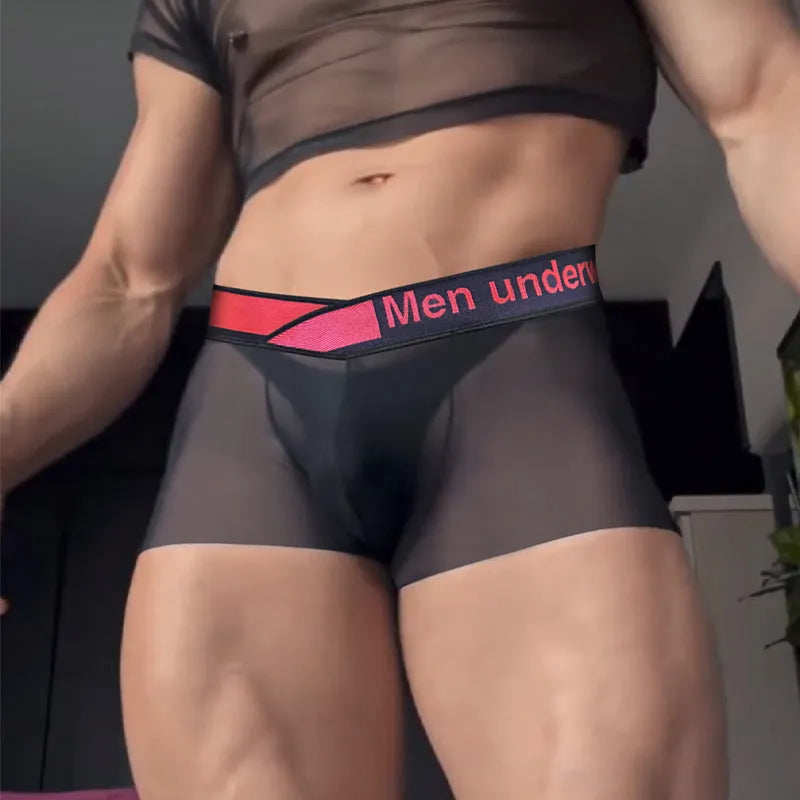 Men's low waist seamless underwear with gradient laser pattern in black, on a mannequin.