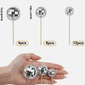 Glass disco ball cake decoration with wooden stick on a celebration cake