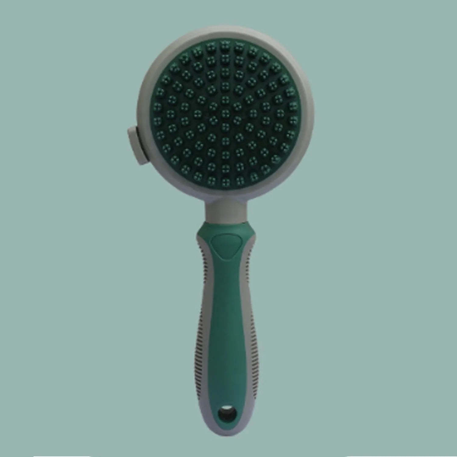 Pink and green double-sided cat brush with flea comb and release button for pet grooming.