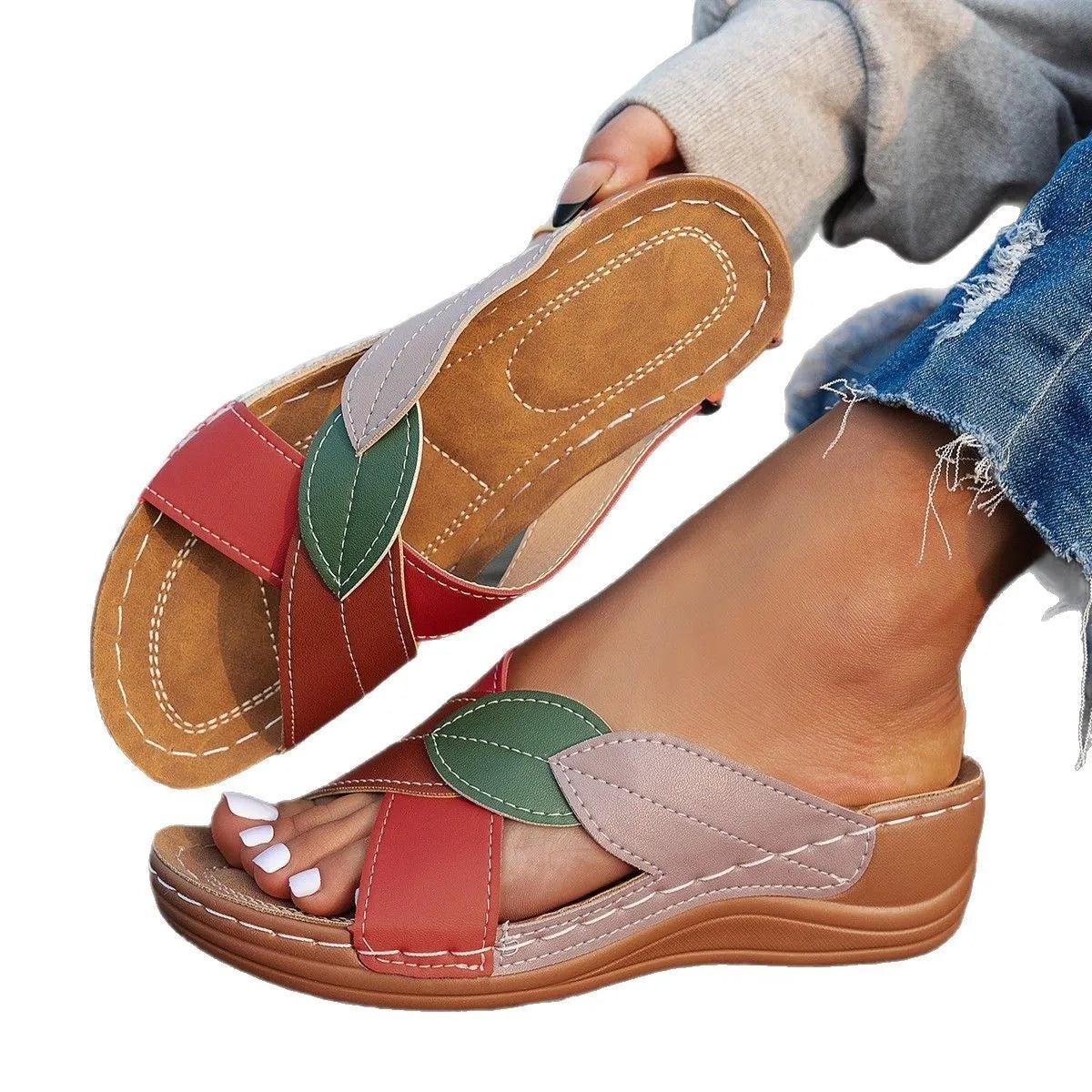 Women's black thick-soled slippers with cross-straps and a peep-toe opening on a white background.