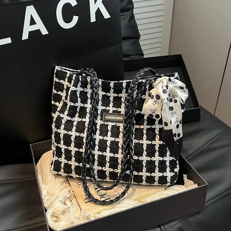 Wool blend shoulder bag in horizontal square shape with organisational compartments and woven sewing details