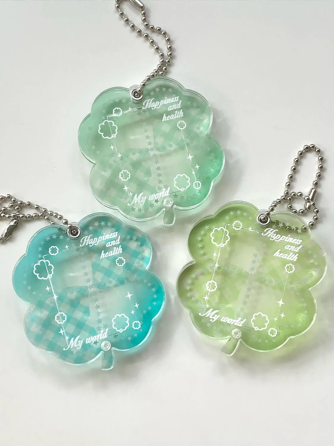 Acrylic four-leaf clover mobile phone pendant charm in blue, green, or mint colour options