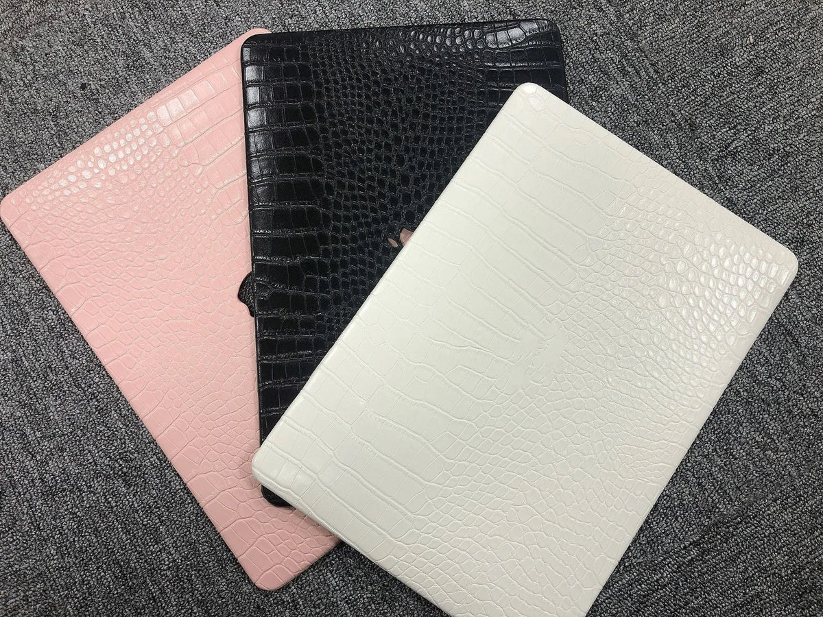 Crocodile pattern laptop protective case for MacBook Pro and Air in black, white or soft pink with hollow Apple logo.