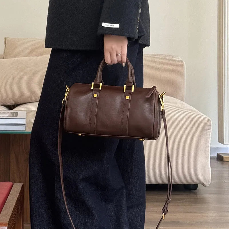 Retro portable cowhide crossbody bag in pillow shape with sewing thread detail, black colour