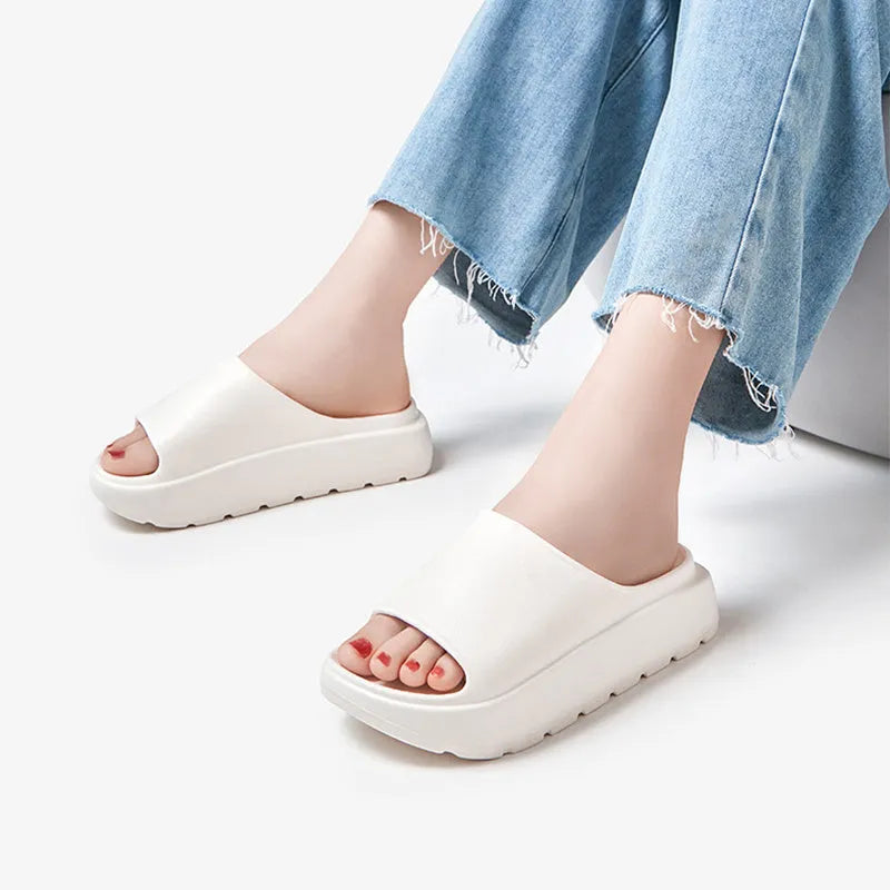 Women's beige EVA fish mouth slippers with a thick 5.5cm sole on a tiled floor.
