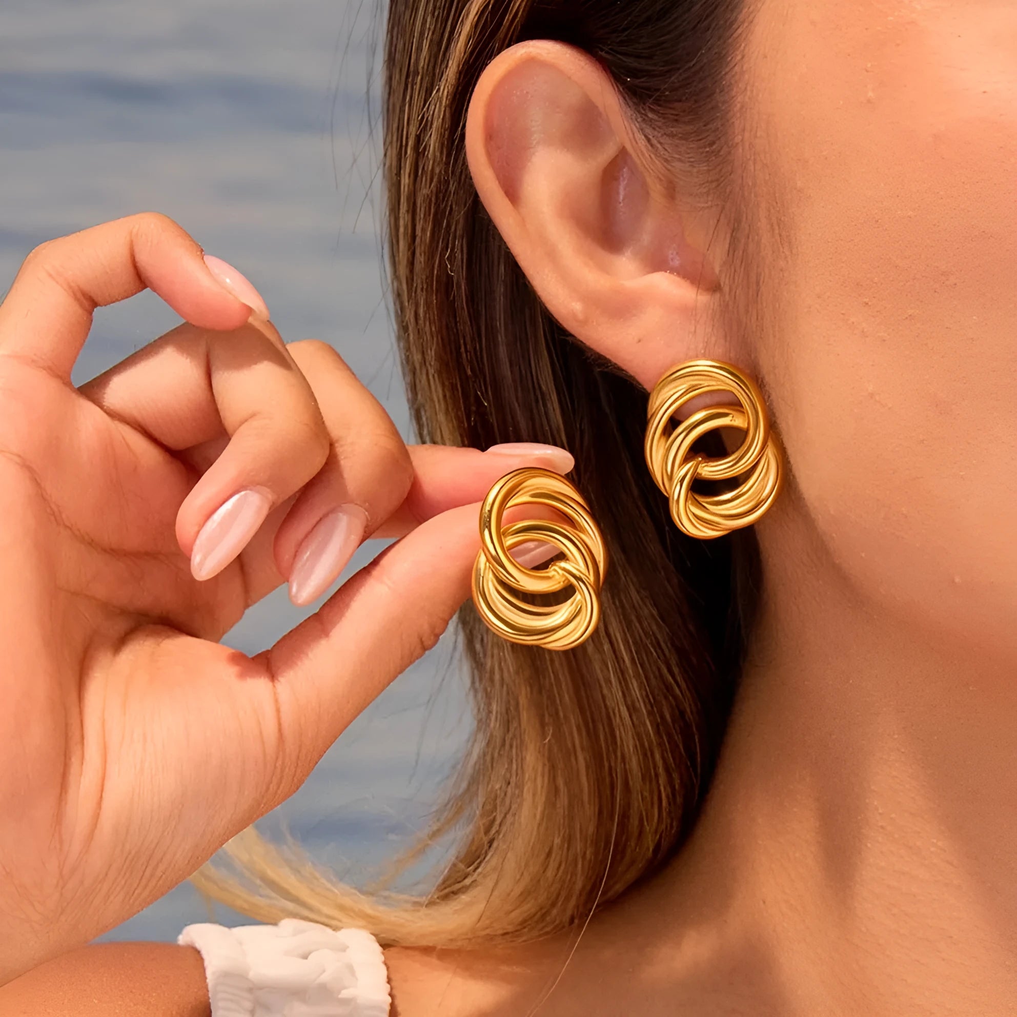 Gold geometric stud earrings with 18K electroplated finish on stainless steel