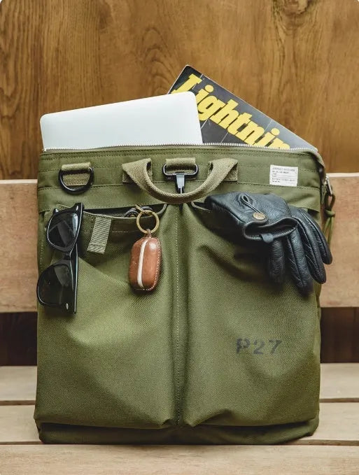 Canvas messenger bag in charcoal black with shoulder strap showing laptop compartment