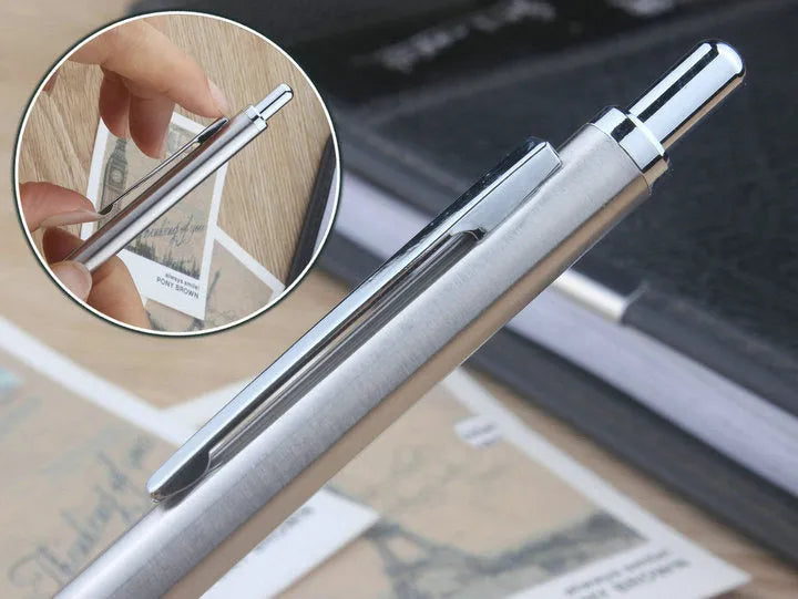 Silver metal automatic mechanical pencil with six compatible lead sizes from 0.5mm to 2.0mm on a notebook.
