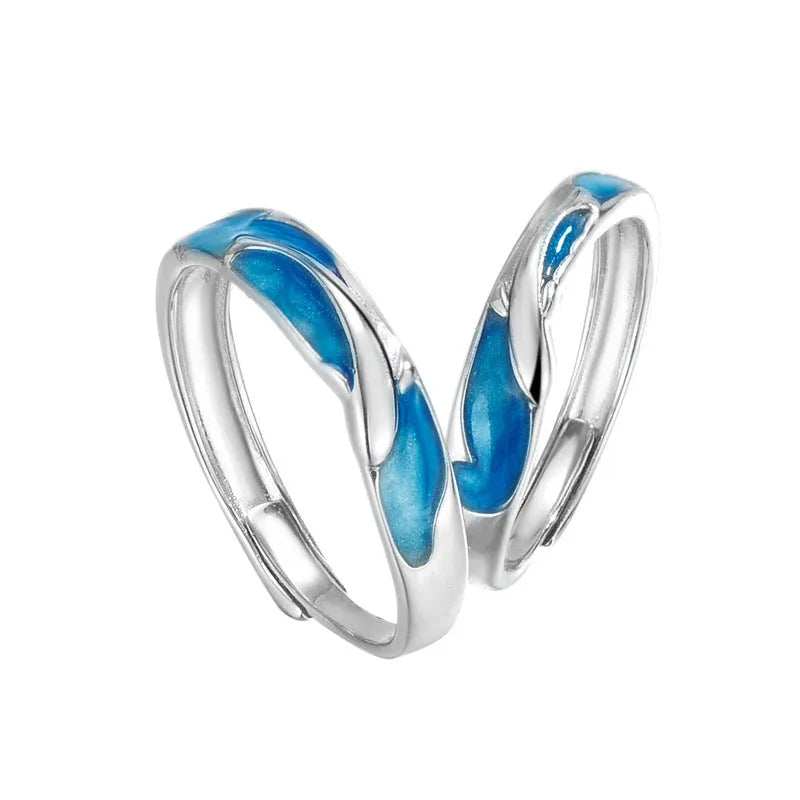 Silver adjustable couple ring with dolphin motif simple style on surface