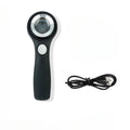 Black metal jeweller's loupe magnifying glass with adjustable stand on a wooden desk.