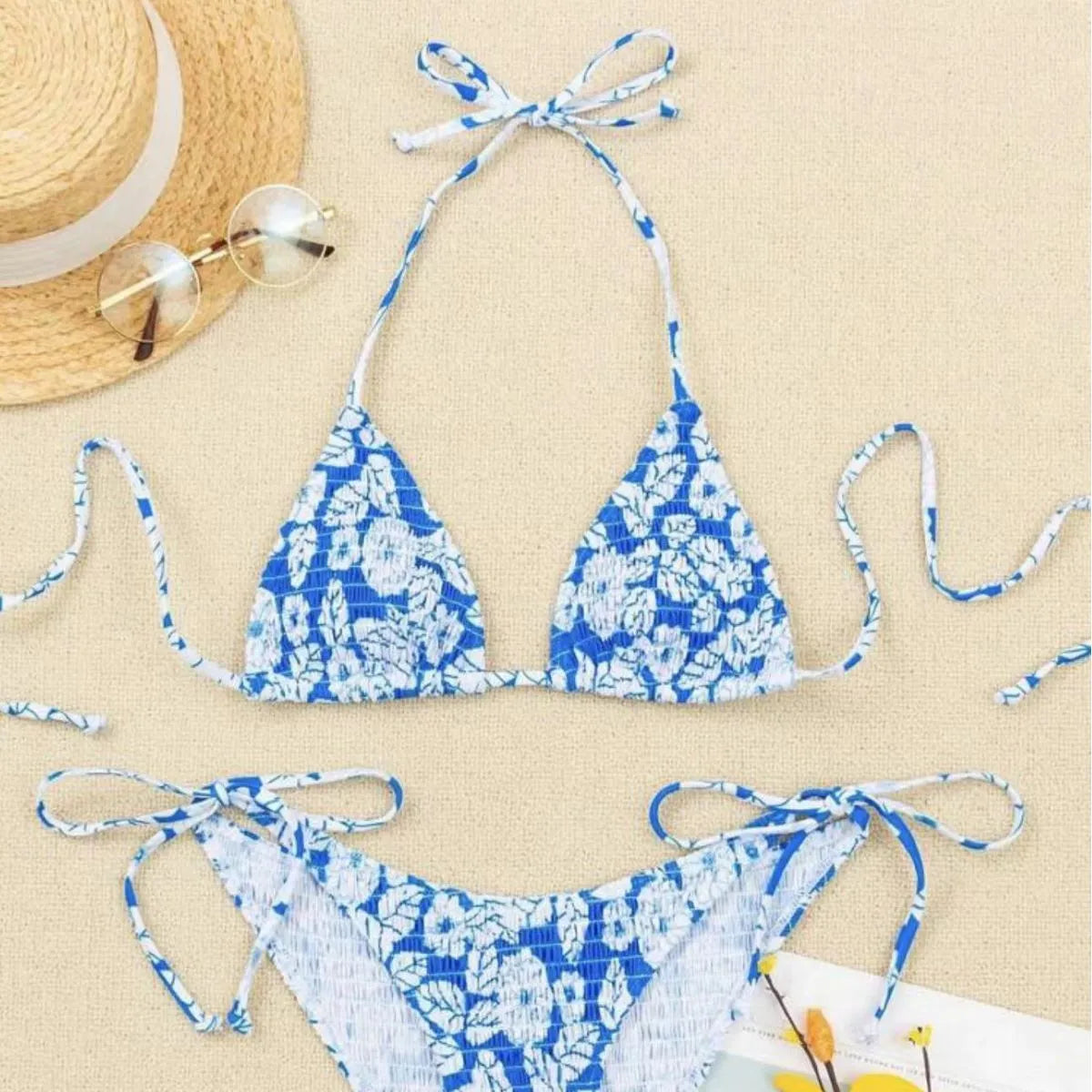 Women's pink floral halter neck swimsuit with briefs on a mannequin.