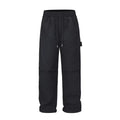 Black men's baggy paratrooper pants with an elastic drawstring waist on a neutral background.