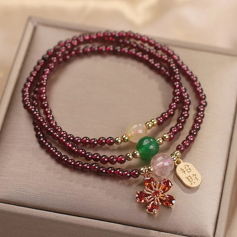 Natural crystal pomegranate red cherry blossom bracelet with sequins on wrist