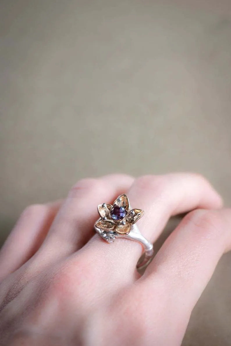 Silver two-tone floral design women's alloy ring on a geometric band.