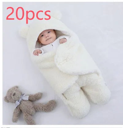A baby quilted sleeping bag wrapper in a cotton blend fabric, shown in a light blue colour, laid flat.