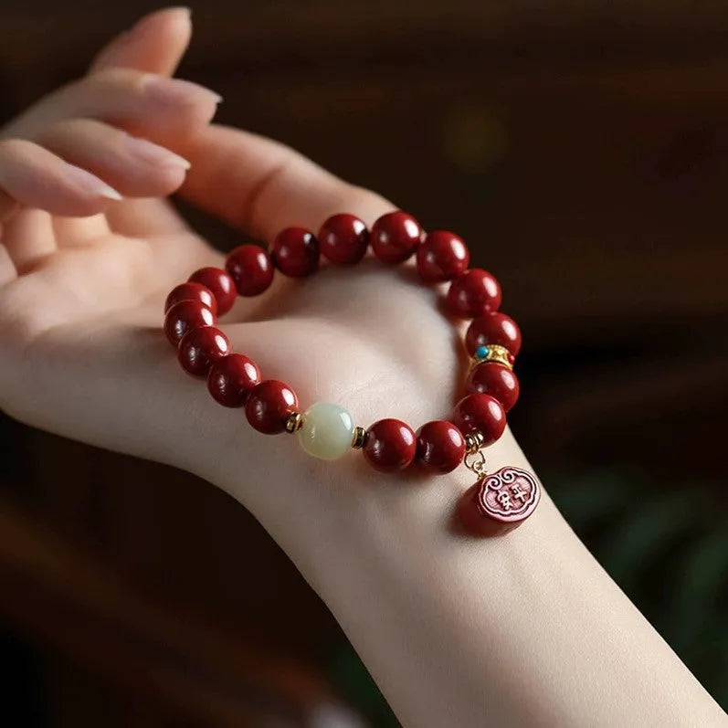 Red cinnabar bracelet with Ping An Fu Lu design in Emperor sandstone style showing 8mm and 10mm size options
