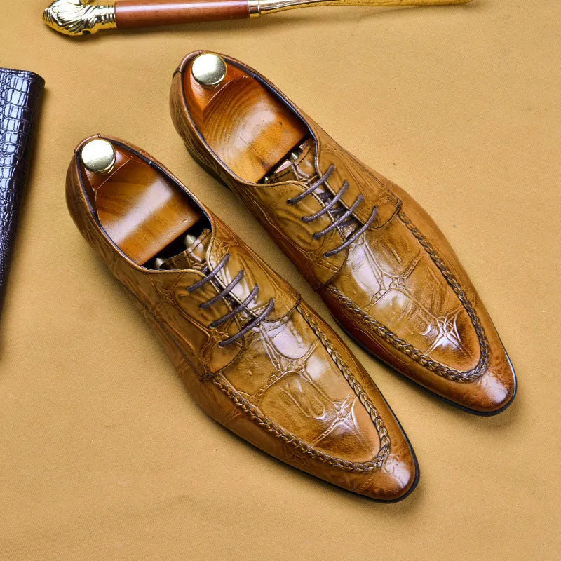Men's black and brown leather loafers with alligator pattern and a horsebit buckle on a low rubber sole.