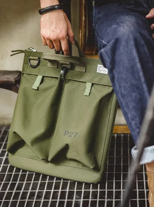 Canvas messenger bag in charcoal black with shoulder strap showing laptop compartment