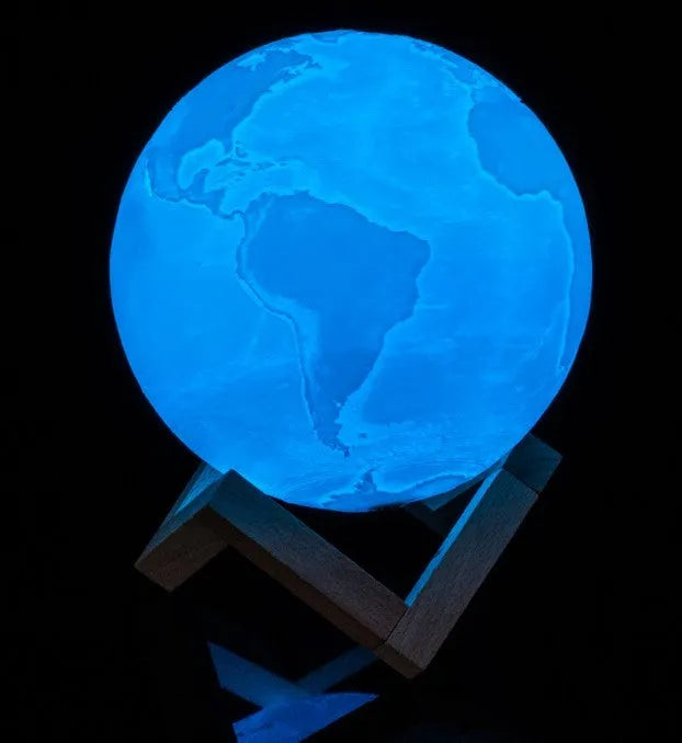 3D printed white moon lamp on a wooden stand with touch-control ring at base