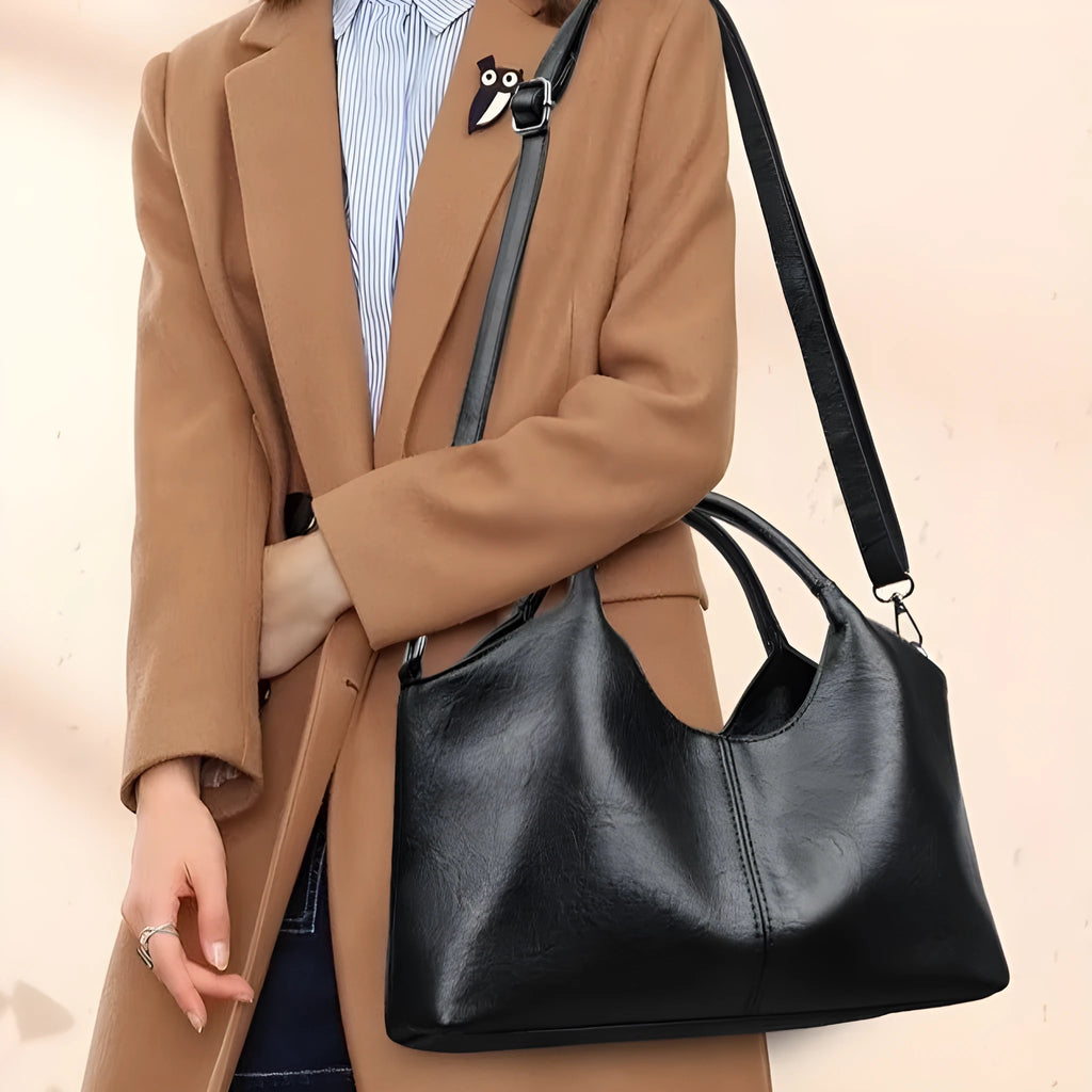 Women's soft genuine leather cross-body bag in beige colour with large capacity.