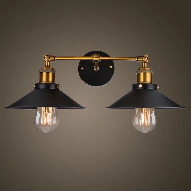 Black double head American retro industrial style iron wall lamp on a wall.
