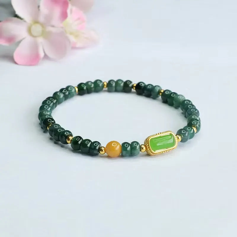 Natural stone blue water jade beaded bracelet with round and oval geometric beads on a white background