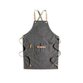 Canvas cross-strap apron in camel colour on hanger