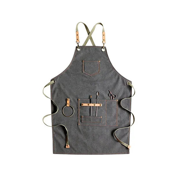 Canvas cross-strap apron in camel colour on hanger