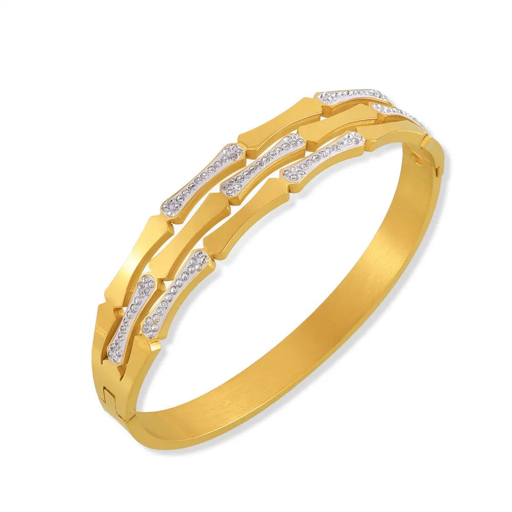 Gold electroplated titanium steel hollow splicing casual bracelet for women, open cuff design on white background