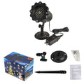 LED Christmas snowflake laser projector with white moving patterns on a dark garden wall at night