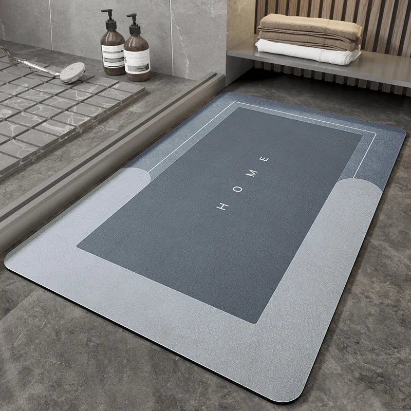 Blended fibre machine woven bathroom floor mat in blue, shown in an oval shape on a tiled floor.