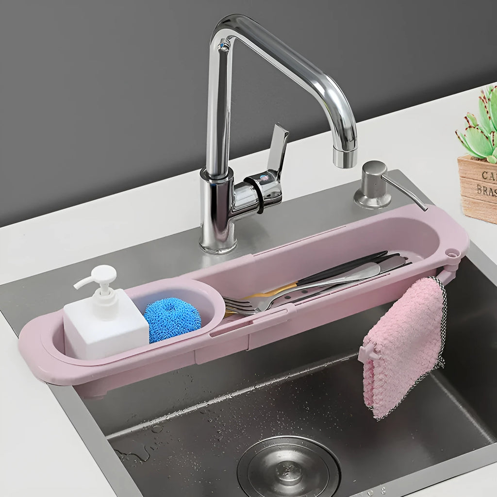 Adjustable telescopic kitchen sink rack organiser holding soap and sponge by drain