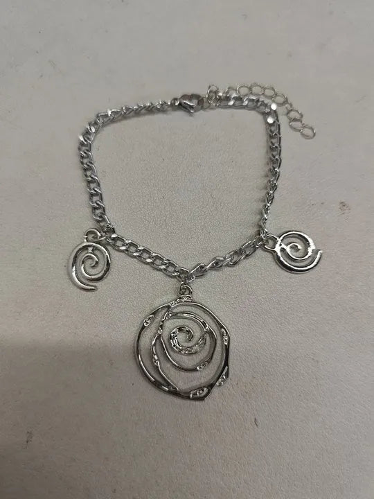 Women's spiral donut jewellery set showing necklace, bracelet and earrings in gold finish