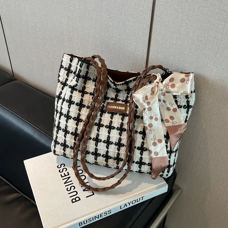 Wool blend shoulder bag in horizontal square shape with organisational compartments and woven sewing details