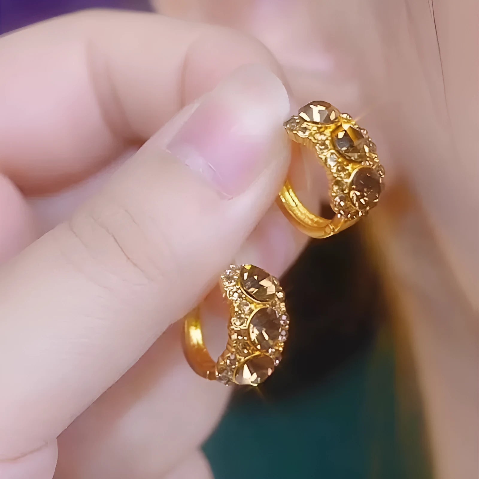 Gold metal hoop earrings with brown zircon stones in geometric shape