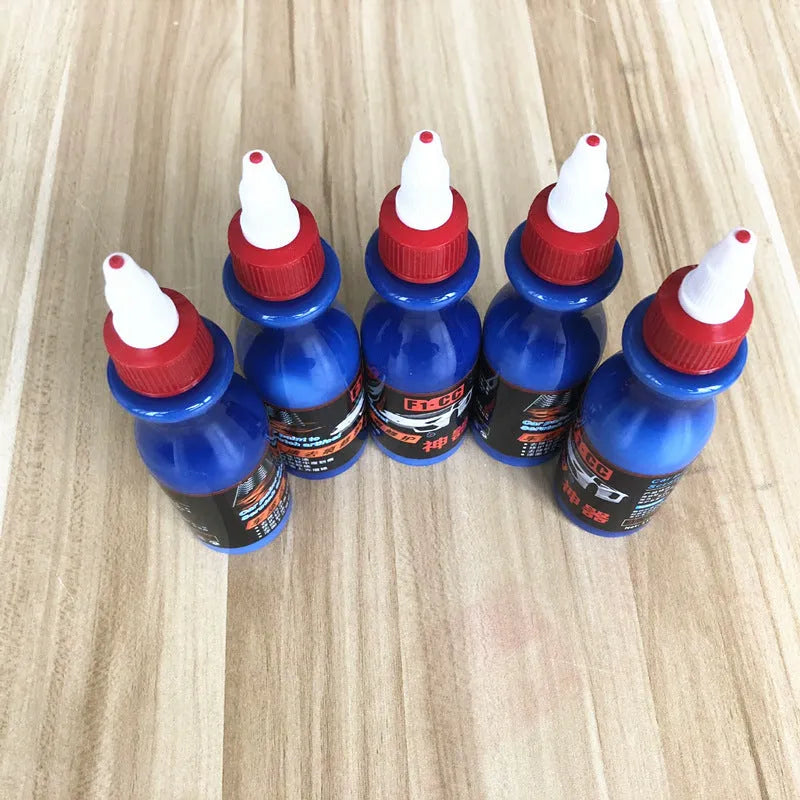 Small blue car wiping tool with scratch repair agent bottle for automotive paintwork touch-up applications