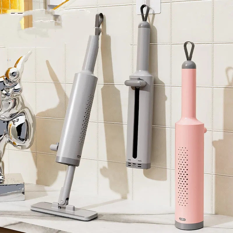 Rotatable self-squeeze mini mop with pink handle, crevice brush, and two microfiber pads on a tiled floor