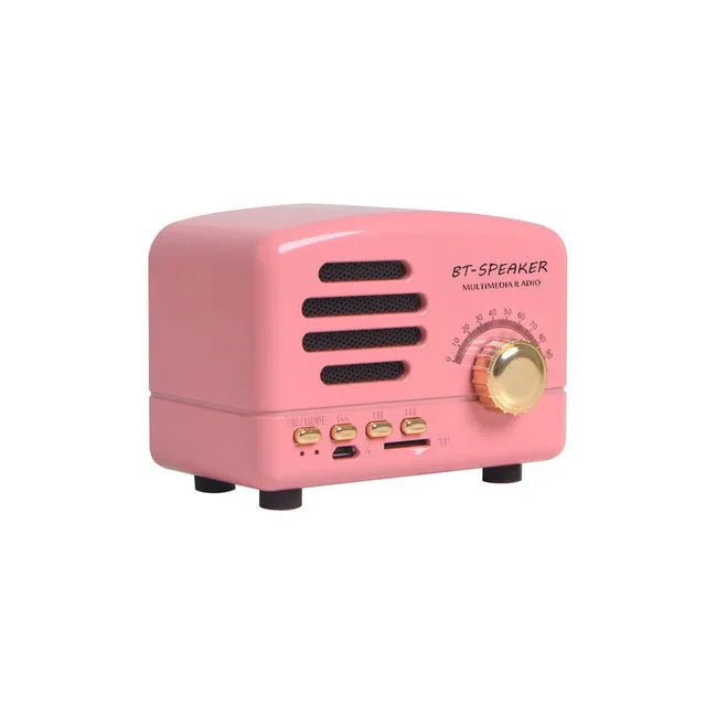 Vintage wood effect Bluetooth speaker in pink, black and wood grain colours showing compact size