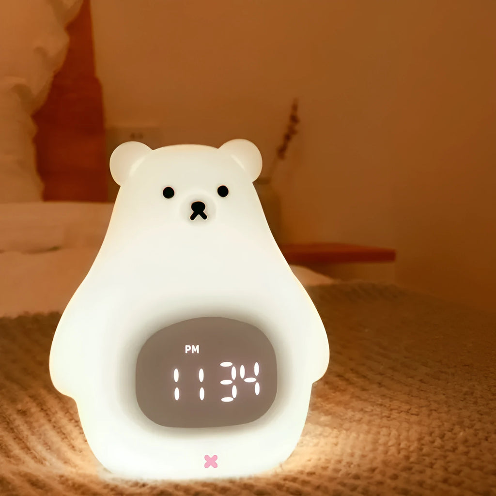 White silicone cartoon bear night light with remote control on a surface.
