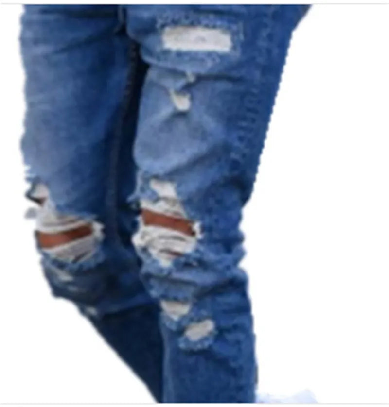 Deep blue men's jeans with distressed hole details and five pockets laid flat.