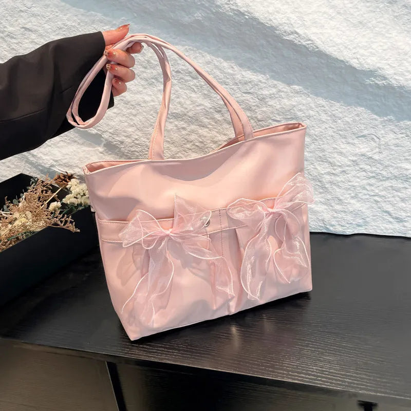 College style bow tote bag in black with double shoulder straps and decorative bow