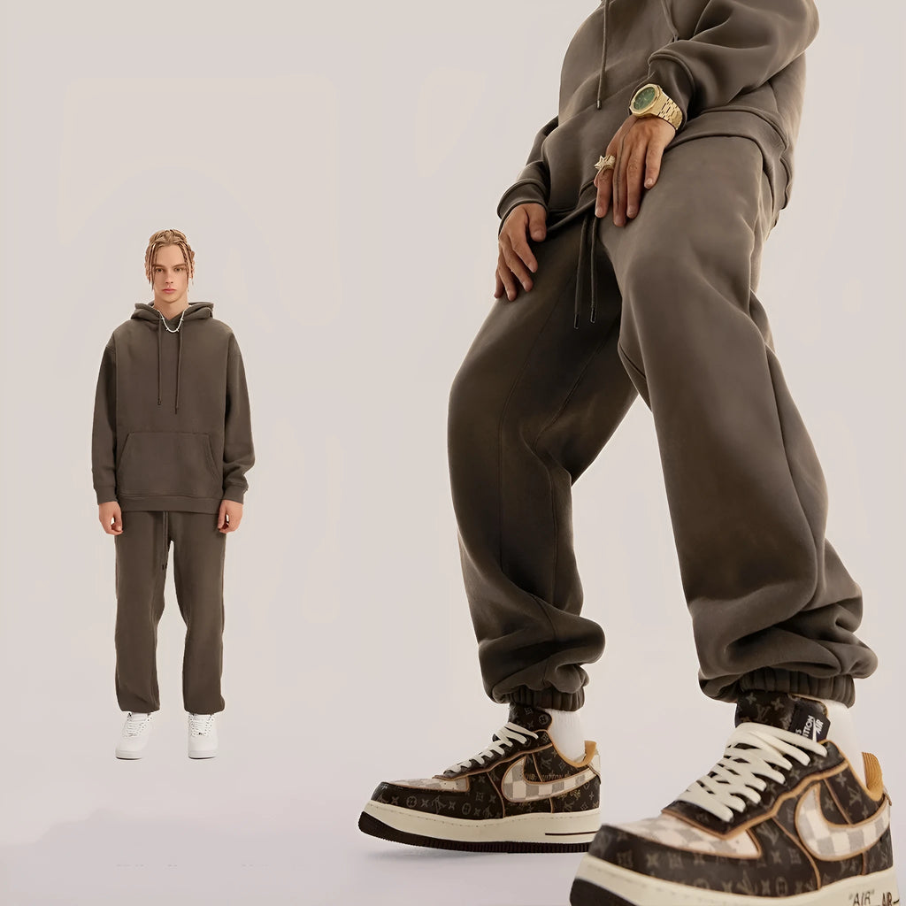 Men's solid colour velvet cotton sweatpants with ankle banding detail shown in dark brown.